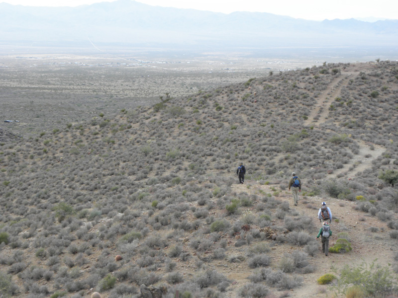 74-group_walking_along_old_road_towards_are_vehicles