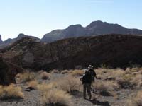 15-Tom_and_Barb_hiking_through_the_wash-Pyramid_Peak_in_distance