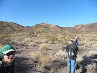 04-starting_the_hike-up_ridgeline_in_middle_with_hump-down_wash_drainage_above_Eric_and_Ed