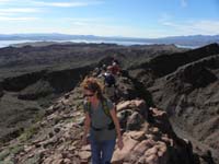 17-group_hiking_along_ridgeline_with_Lake_Mead_in_background