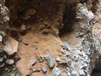 12-fanglomerate_rock_with_loose_deposited_dirt_few_feet_above_floor