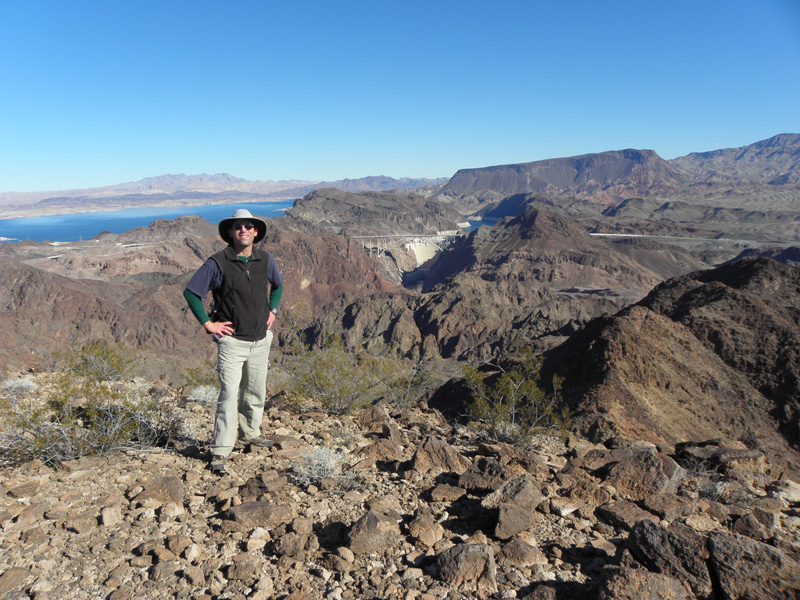 13-me_on_peak_with_Hoover_Dam,Bridge,Lake_Mead,Fortification_Hill_in_background