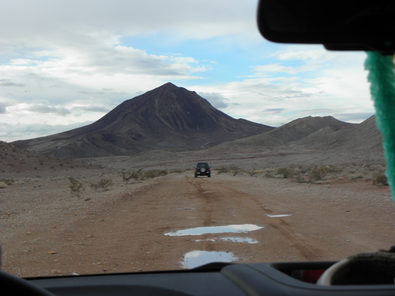 01-driving_up_dirt_road_to_base_of_Lava_Butte-some_puddles_in_the_road