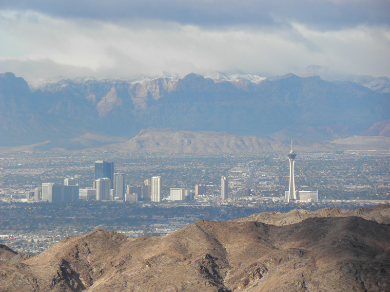 19-scenic_view_from_peak-looking_W-zoom_of_north_Las_Vegas_Strip-Red_Rock_with_high_peaks_capped_by_clouds