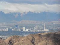 19-scenic_view_from_peak-looking_W-zoom_of_north_Las_Vegas_Strip-Red_Rock_with_high_peaks_capped_by_clouds