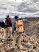 73-Ed_and_I_are_discussing_options_for_descending_the_cliff_wall_to_area_below_us-from_Laszlo