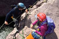 54-anchor_is_fished_out_of_the_water-setting_up_for_our_rappel,replacing_link_since_submerged