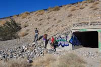 33-climbing_over_the_fence-lots_of_extra_graffiti-we_drove_the_Tesla_to_the_hike