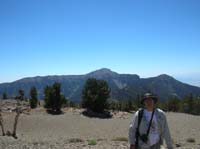 46-Chris_on_Mummy's_Tummy_with_Mt._Charleston_in_the_background-11,553_feet_elevation