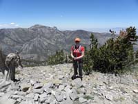 26-Heather_on_the_peak_with_Mummy_Mountain_in_distance