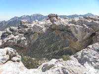 33-neat_delicate_not_stable_arch-Mummy_Mountain_and_Mt_Charleston_in_background
