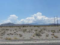 43-drive_home_along_Hwy_93_looking_back_to_mountains-1243-much_bigger_storm_clouds-done_in_time