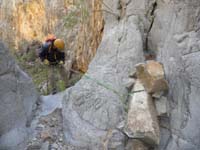 52-Ed_rappeling-rock_anchor_wedged_against_a_slab_of_rock_for_stability