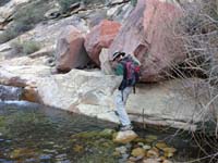 13-getting_set_to_climb_over_rock_slab_without_falling_in_the_water-from_Larry