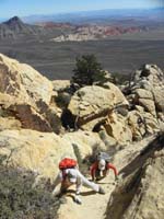 25-scrambling_up_exposed_rock_with_lots_of_grip_and_friction-pretty_scenery_in_background