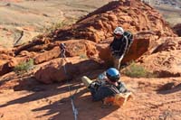 08-Luba_heading_down_the_1st_rappel-anchor_shown