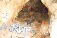 05-one_of_many_small_caves,very_unfortunate_graffiti_or_'dumber'