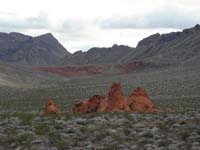 16-looking_back-road_to_Valley_of_Fire_is_below_mountain_to_upper_left