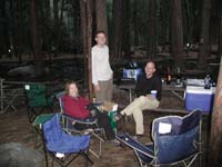 13-Gretchen_Jim_Dave-N._enjoying_our_campsite_with_stream_running_through_it