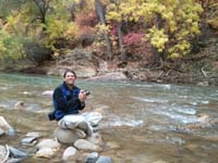 15-me_sitting_on_rock_in_river_taking_pictures_of_Fall_colors