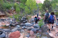 022-group_following_the_crude_trail_up_the_creek,scrambling_along_the_way