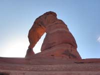10-Delicate_Arch_from_basin_below-tried_to_capture_moment_just_as_sun_peaking_over_rock