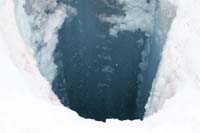 121-glacial_feature-another_moulin_tunnel_with_water_flowing_through_the_glacial_ice