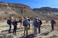 08-group_stopping_to_discuss_plan_with_Paradise_Ridge_in_background