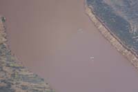 13-zoom_of_river_rafters-cliff_erosion_from_1963,Glen_Canyon_Dam_upstream_completed