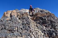 33-Luba_scrambling_down_from_crumbly_summit_block,descending_on_west_side