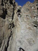 41-we_went_down_a_different_drainage_than_way_up-Peppe_climbing_down_pretty_dry_waterfall-class_3