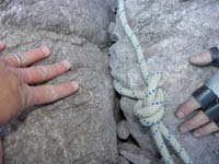 45-rappel_8-bad_anchor-rope_with_little_tail_being_held_by_small_amount_of_sharp_rock