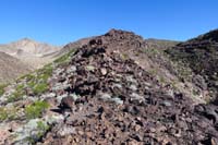 48-looking_back_to_John_walking_along_lava_flow_ridgeline-last_year_I_went_up_right_drainage