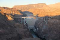 38-Hoover_Dam_and_bridge_with_Fortification_Hill_in_background,setting_sun_perspective