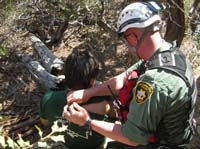 28-SAR_rescuer_assessing_Colin's_right_shoulder