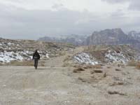 34-Peppe_walking_along_old_road_with_snowy_mountain_views