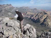 30-me_trying_to_balance_in_the_wind_to_set_camera_for_summit_shot-no_go_too_windy-from_Harlan