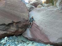 56-Jutta_squeezing_through_rock_in_wash