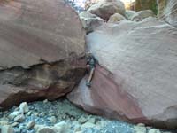 57-Jutta_squeezing_through_rock_in_wash