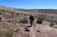 47-looking_back_to_Brett_on_the_trail_and_mine_tailing_obscuring_the_landscape
